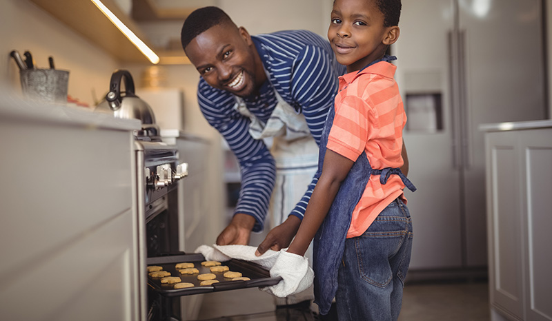 Father and son baking cookies