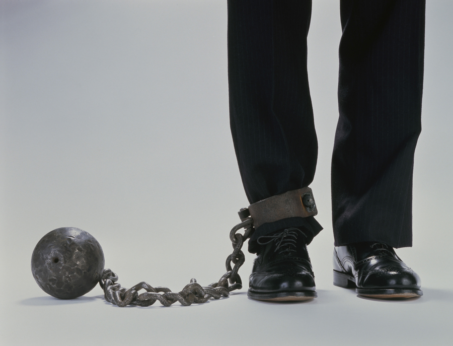 Man with ball and chain attached to leg
