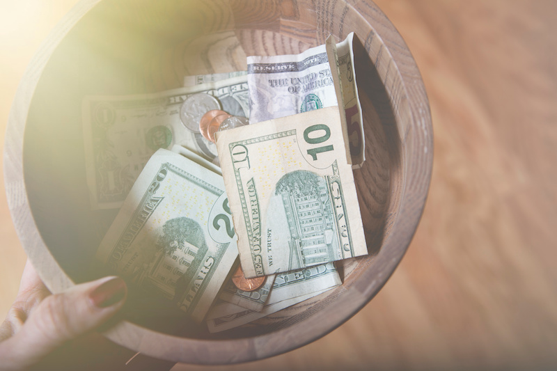 church donation plate with money on it