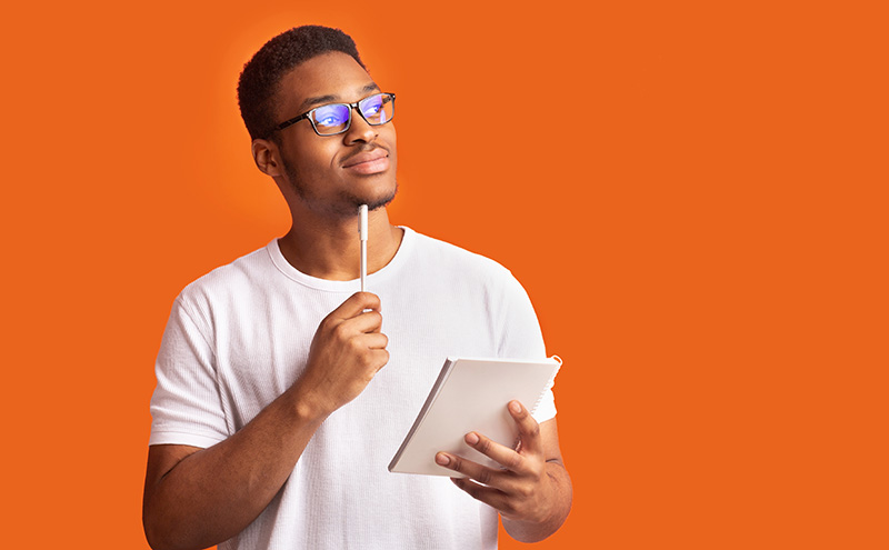 Man thinking holding a notepad