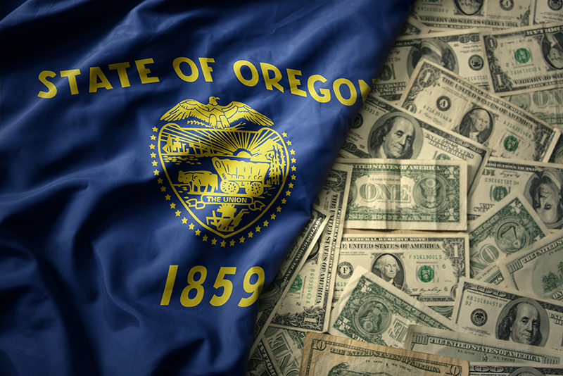 Oregon Flag laying on top of money