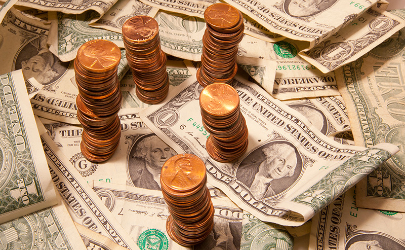 Pennies stacked on dollar bills