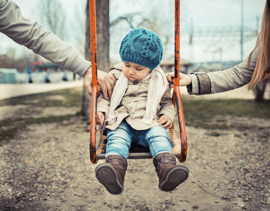 young toddler girl in a swing