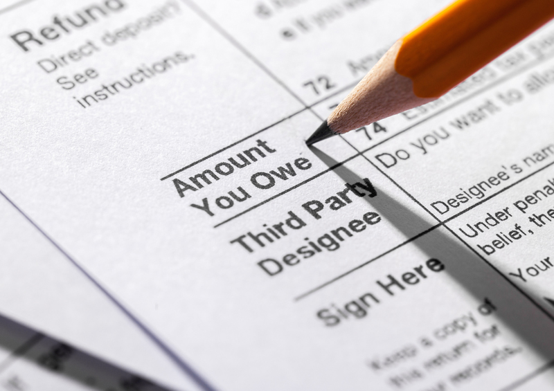 Pencil pointing to the words Amount You Owe on tax form