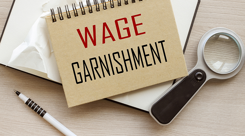 Wage Garnishment written on a notepad