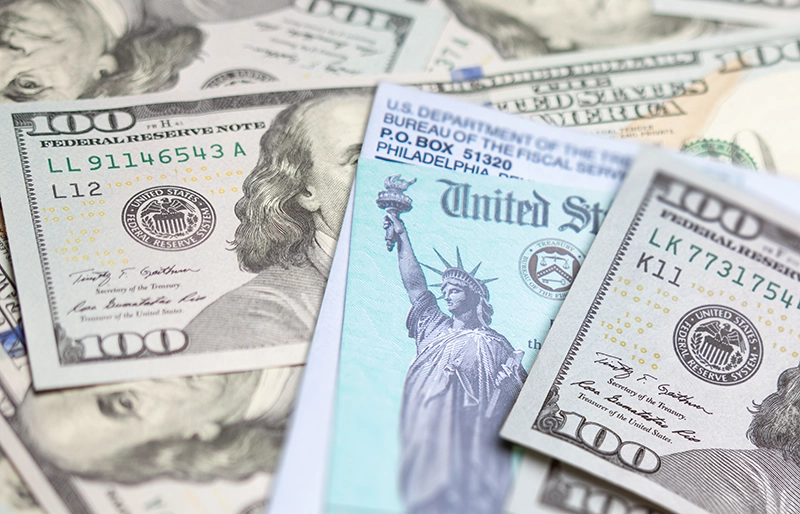 US Treasury Check surrounded by $100 bills