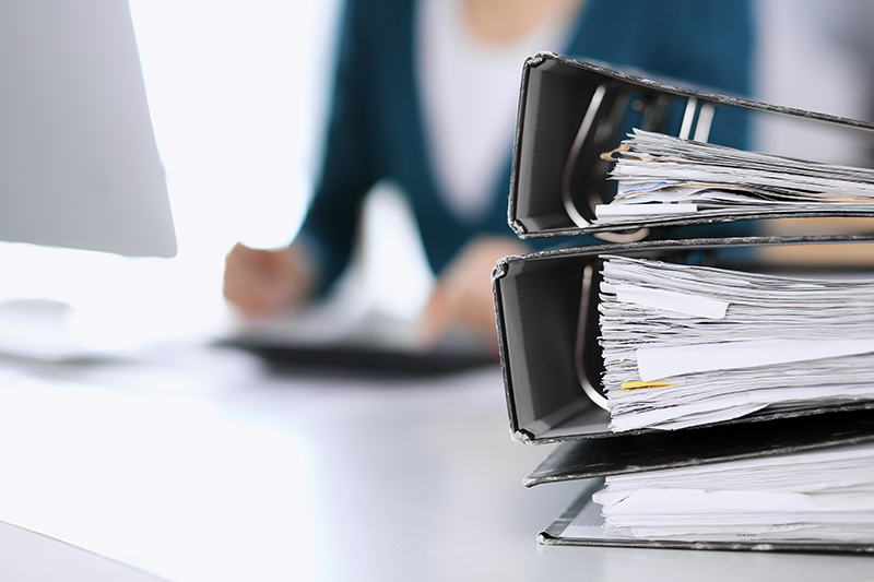 lady working with 3 binders