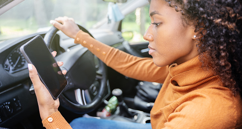 Woman starting mileage tracker on smartphone