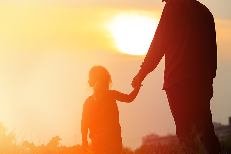 Father and daughter holding hands