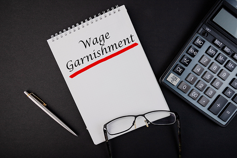 Wage Garnishment written on paper next to calculator