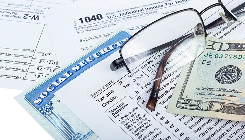 Tax Return, Social Security Card, Glasses, and $20 bill