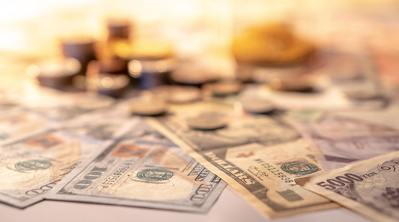 Cash and coins spread out on a table