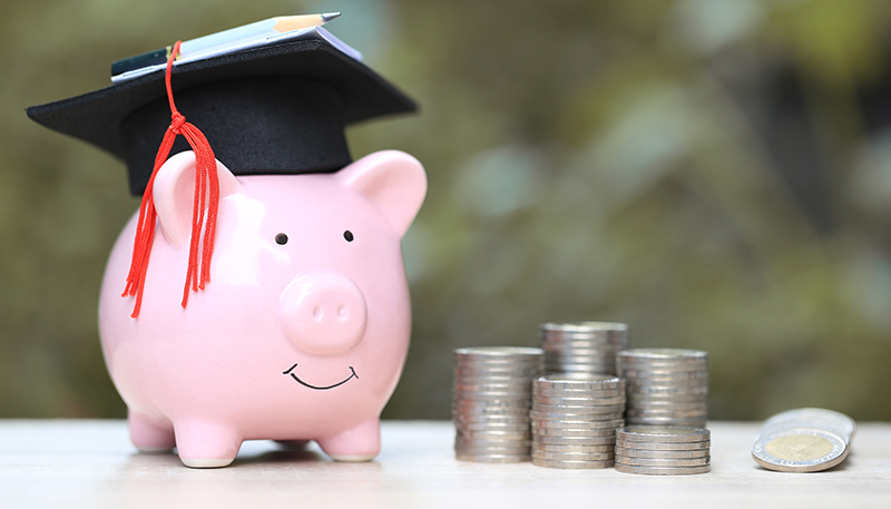 Piggy bank with graduation hat on