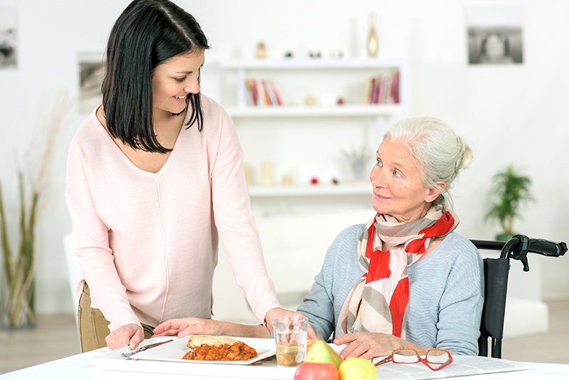 woman helping elderly woman