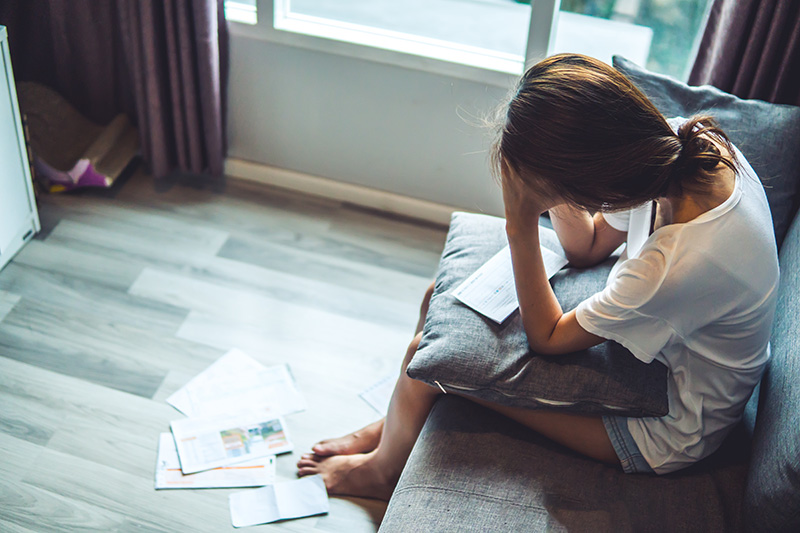 Woman looking at debt letter