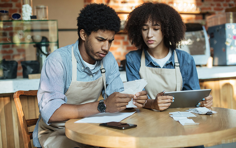 Business owners looking at receipts